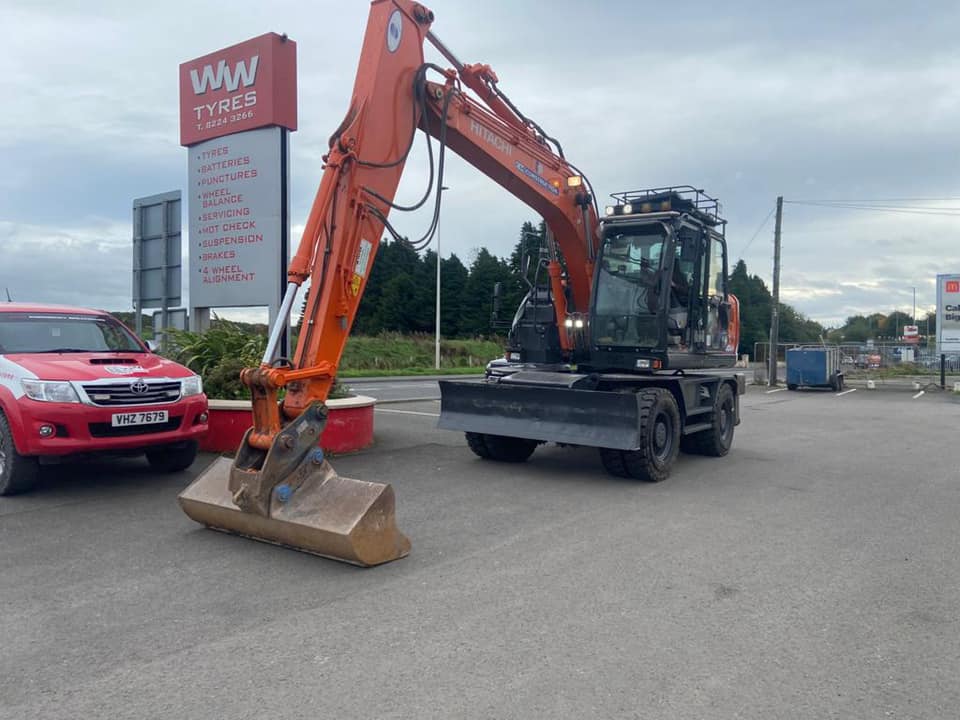 WW Tyres sign with JCB and pickup truck